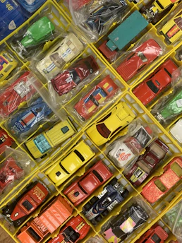 Close-up of various toy tires and accessories arranged neatly on a white background.
