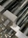 Close-up image of precision-machined aluminium rods stacked neatly in a workshop.