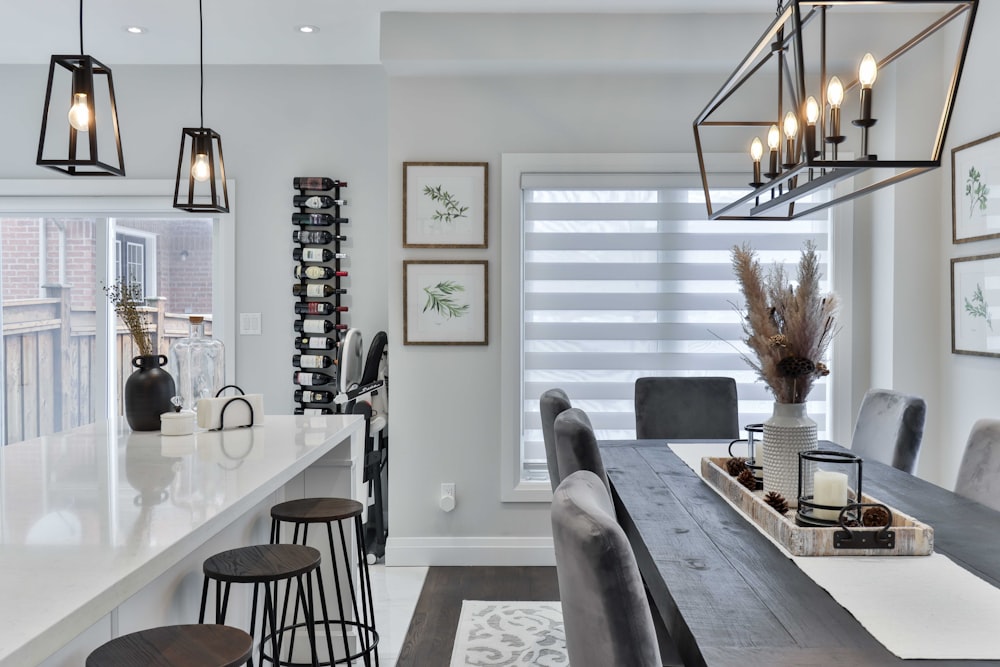 a kitchen with a bar and chairs