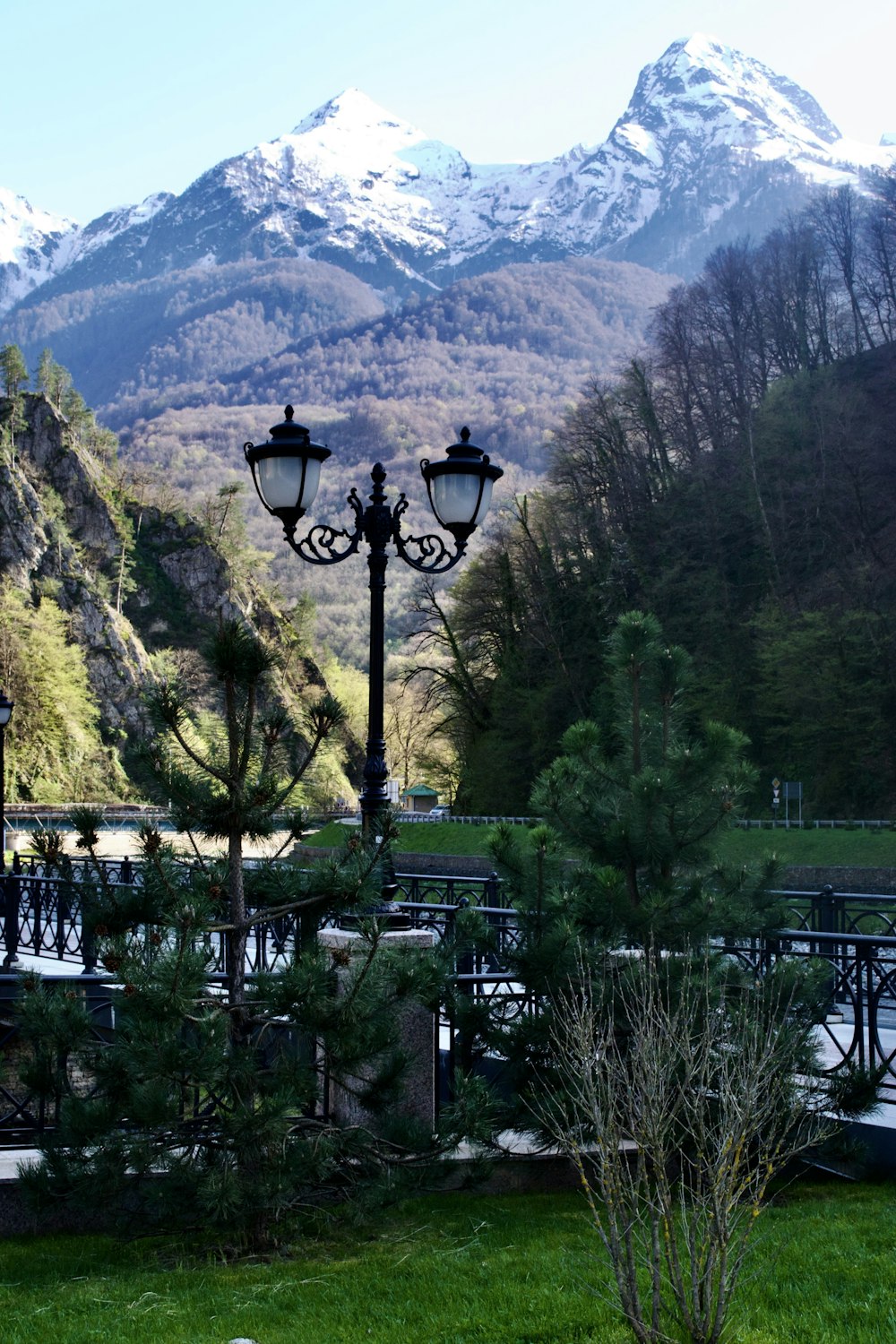 a light post in front of a mountain range