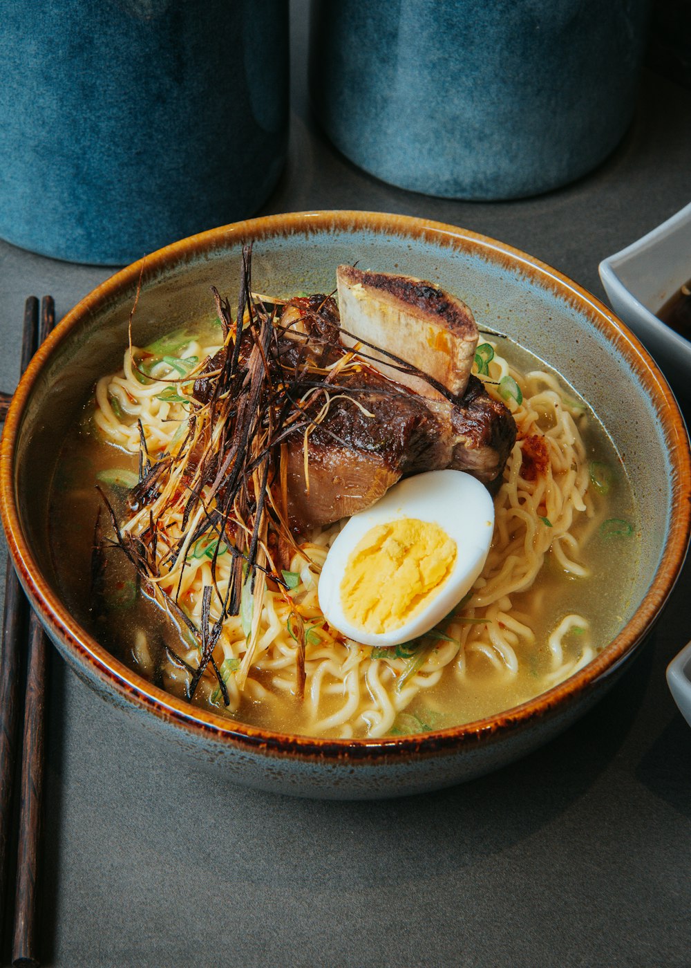 a bowl of ramen with an egg and noodles