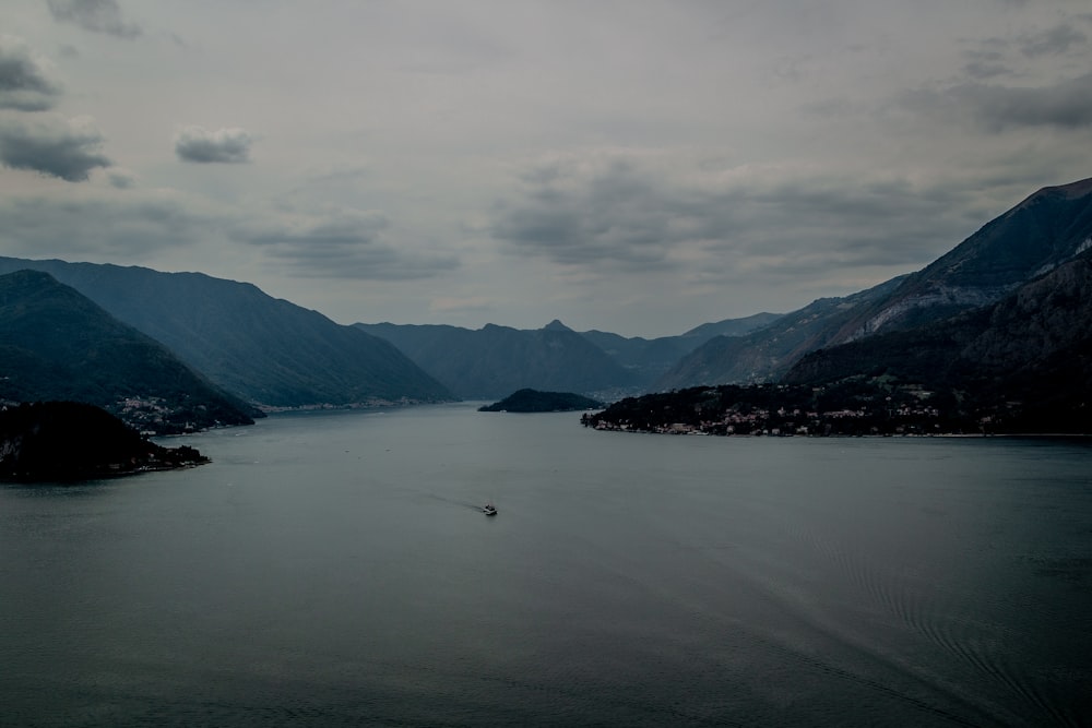 a body of water with mountains in the background