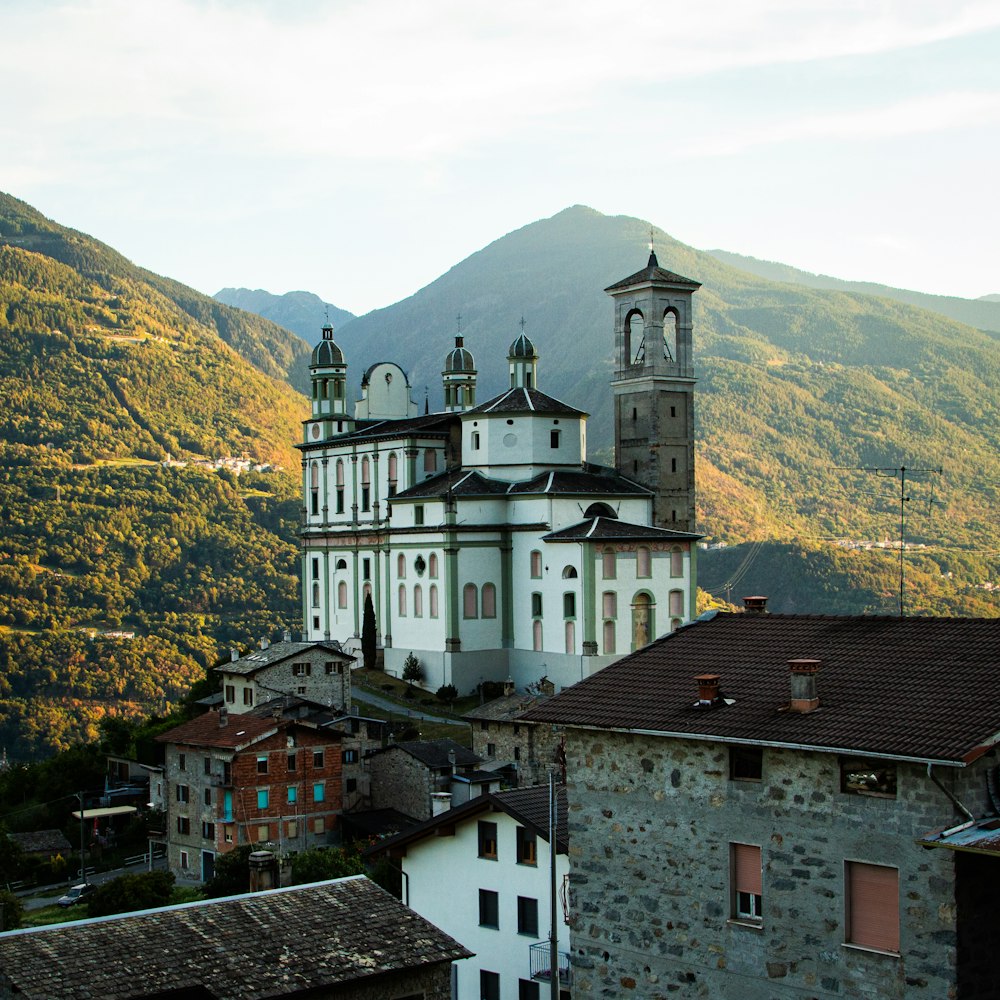 a group of buildings with a hill in the background