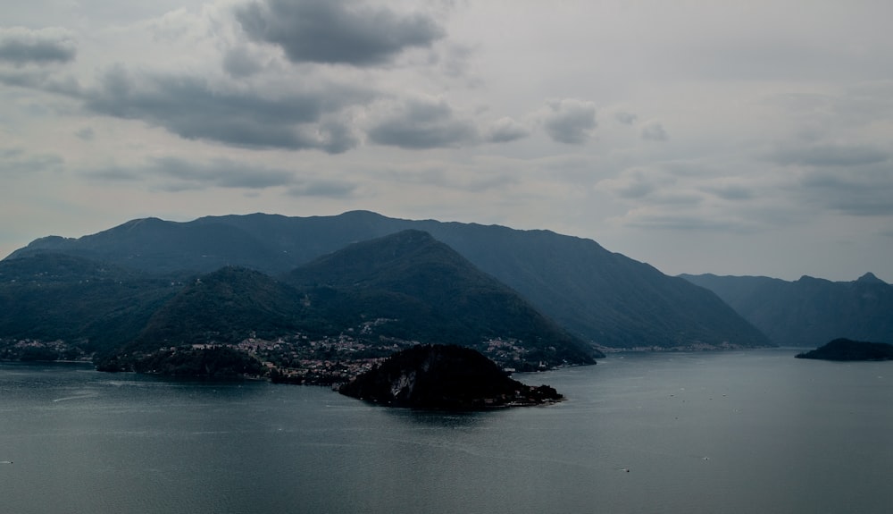 a body of water with mountains in the background