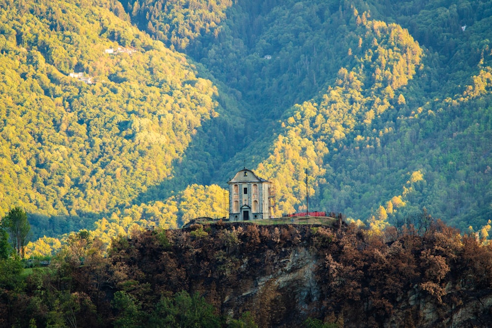 a building on a hill with trees around it