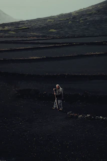 a person standing on a rocky beach