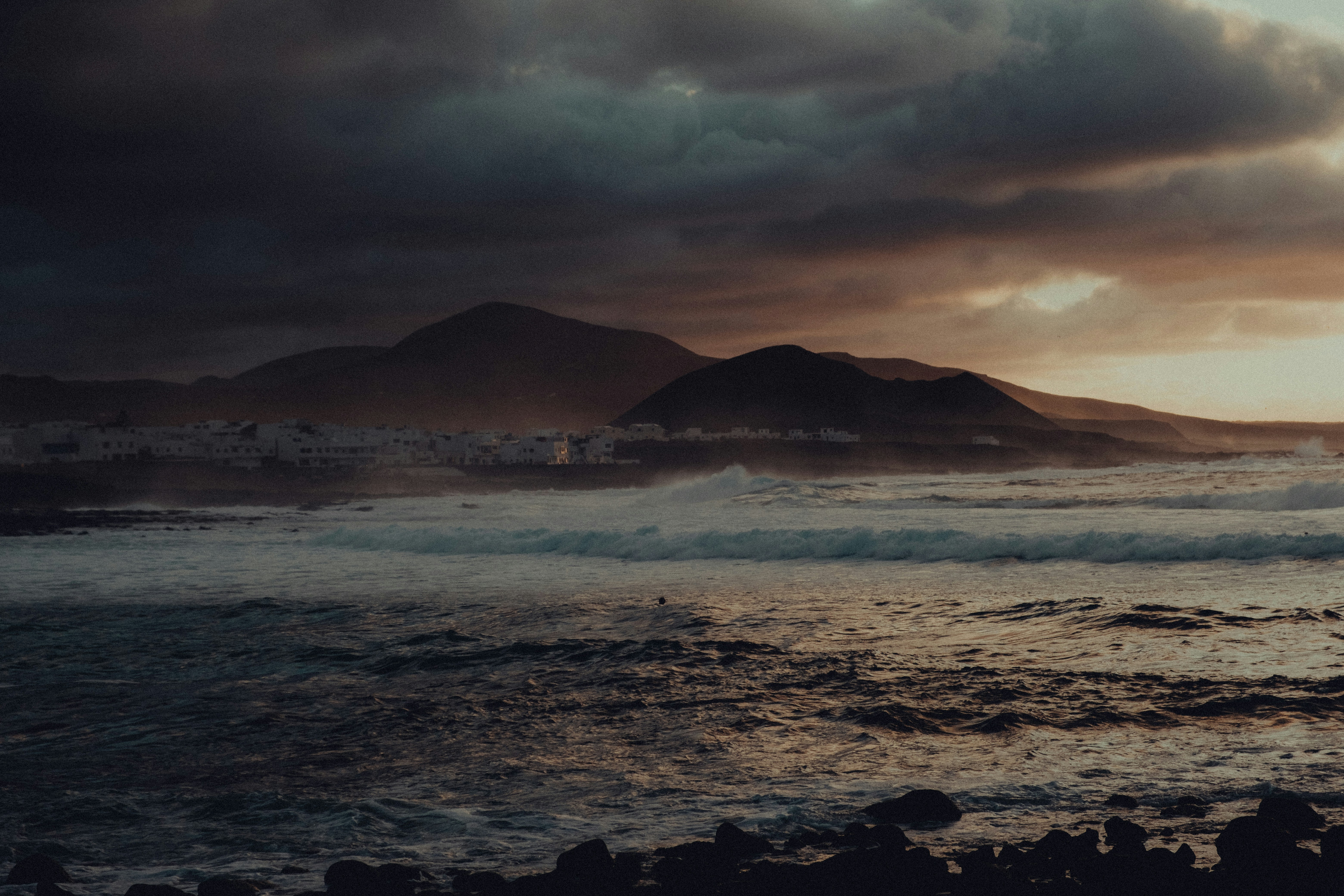 a body of water with mountains in the background