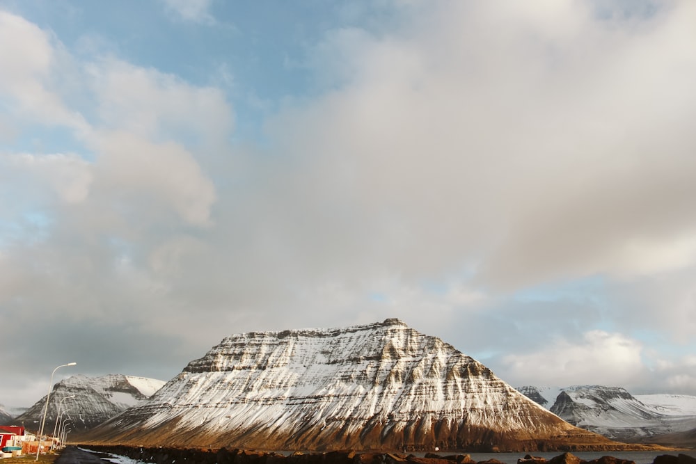 a pyramid with a cloudy sky