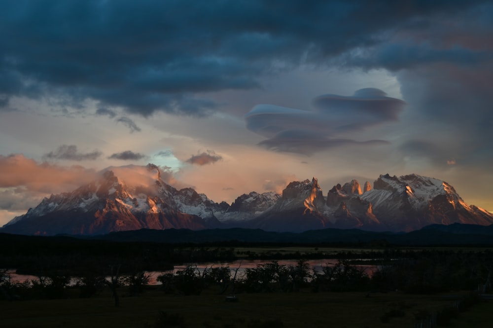 a mountain with clouds in the sky