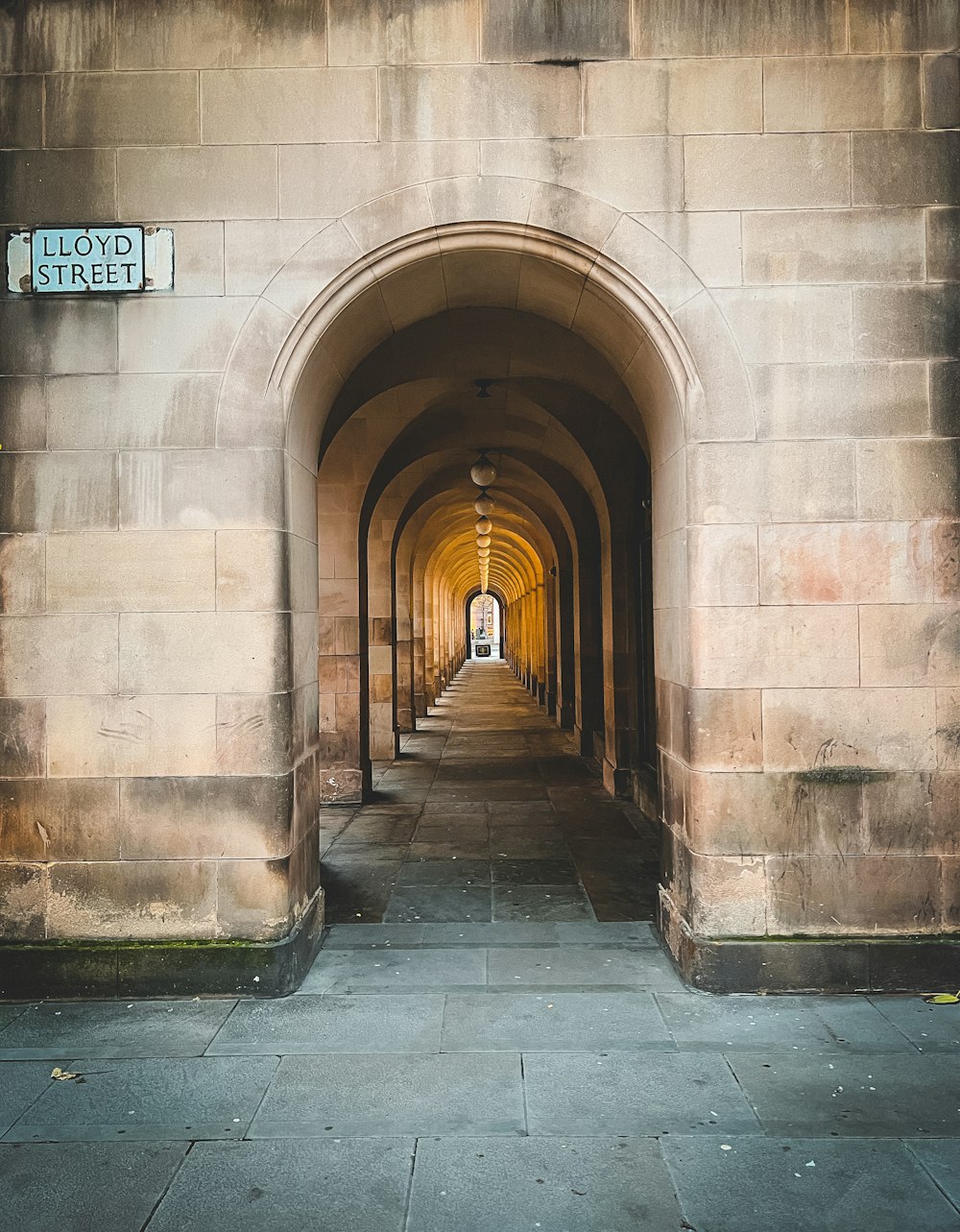 a stone walkway with a stone archway