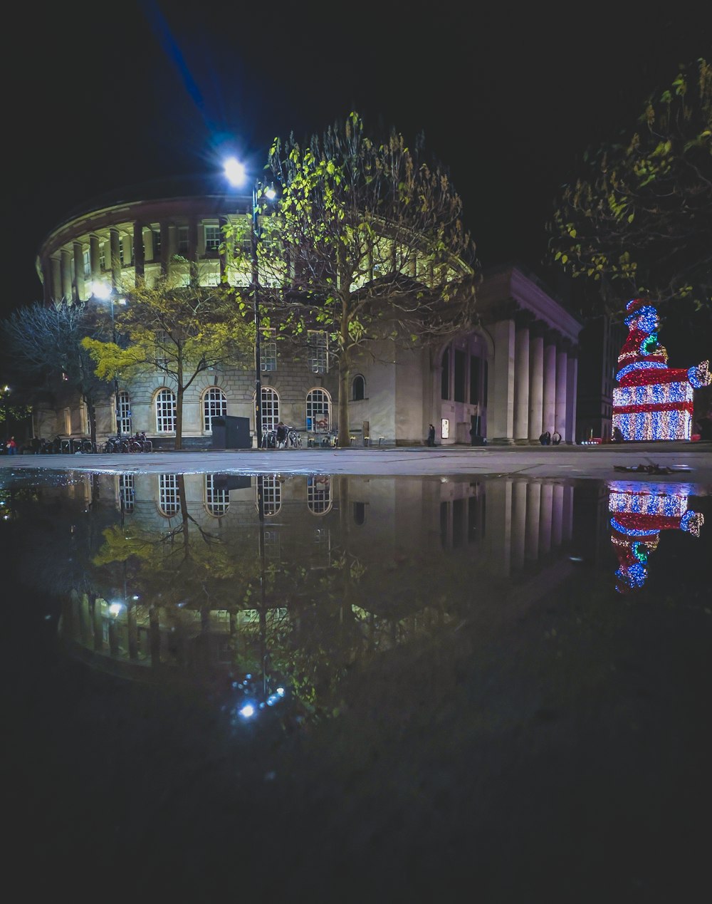 a house with a pool in front of it at night