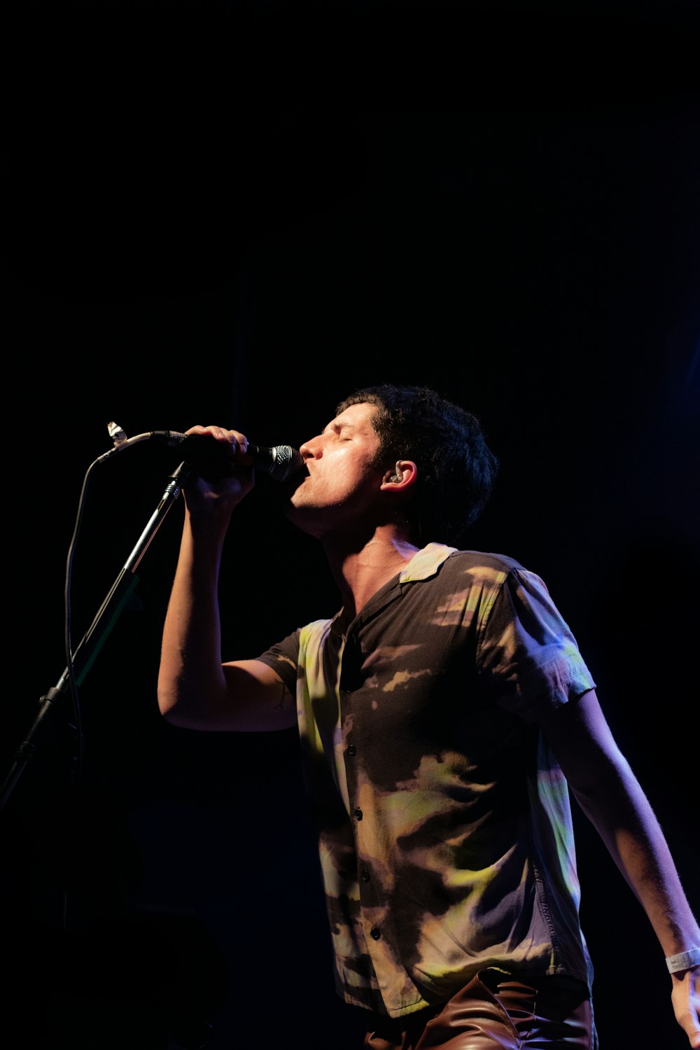 a man singing into a microphone