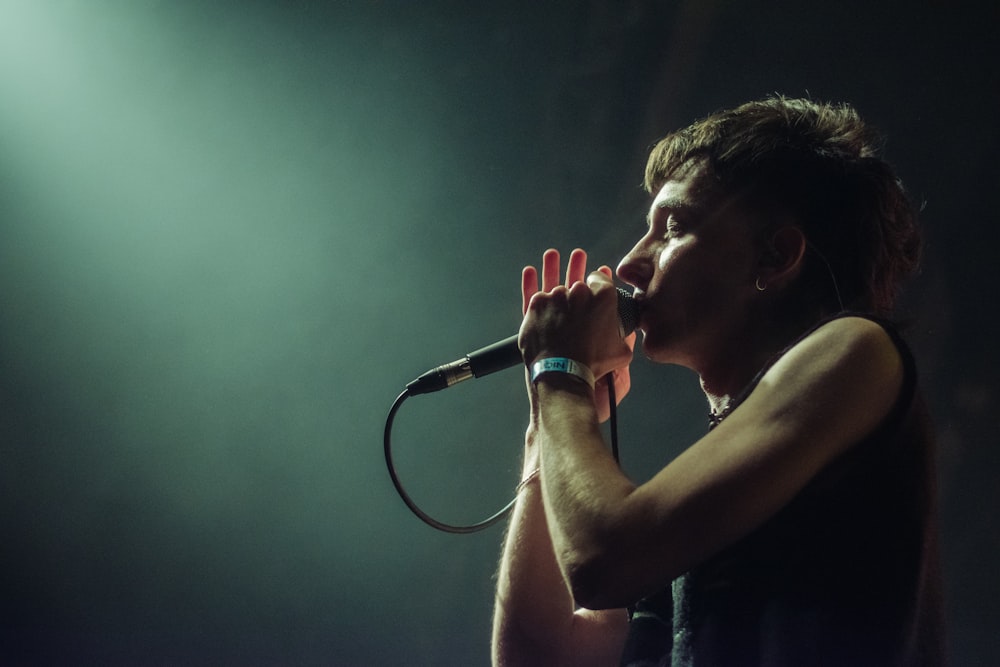 a man singing into a microphone