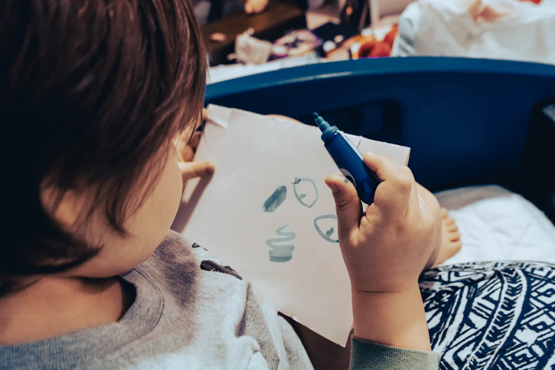Child drawing on white paper