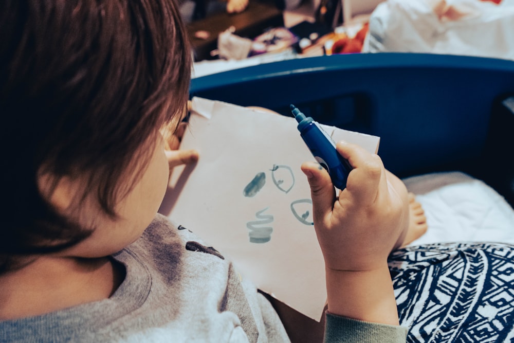 a child drawing on a white paper