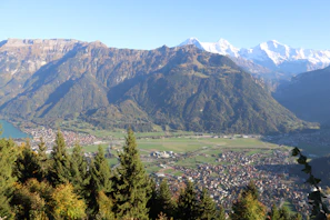 A panoramic view of the Sacred Valley with terraced fields and snow-capped peaks in the background.