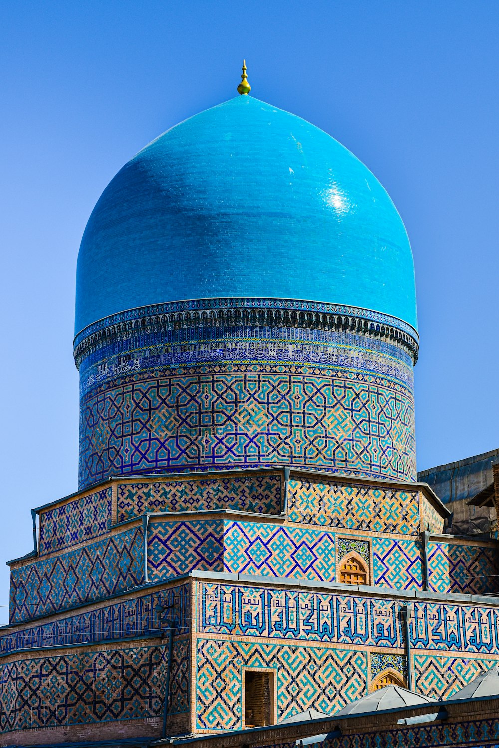 a domed building with a blue sky with Dome of the Rock in the background