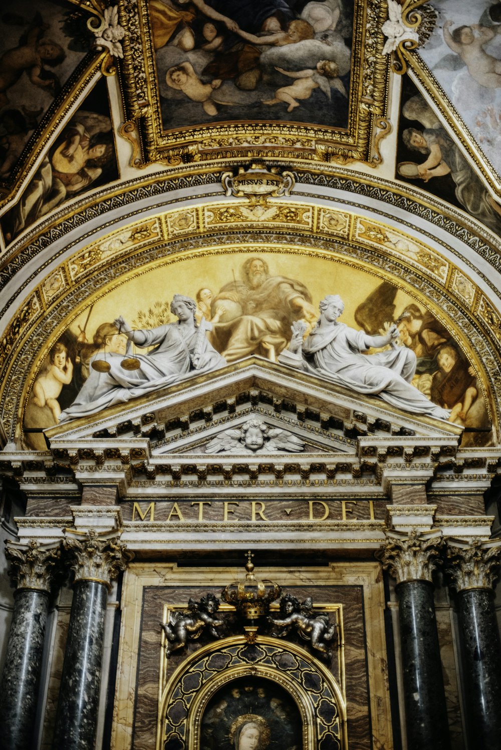 a gold and ornate ceiling with statues