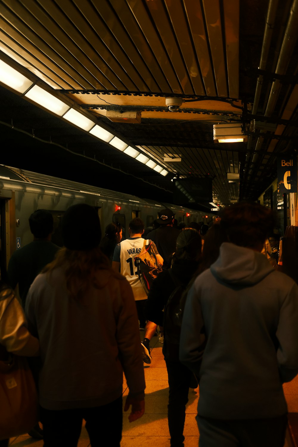 a group of people walking in a train station