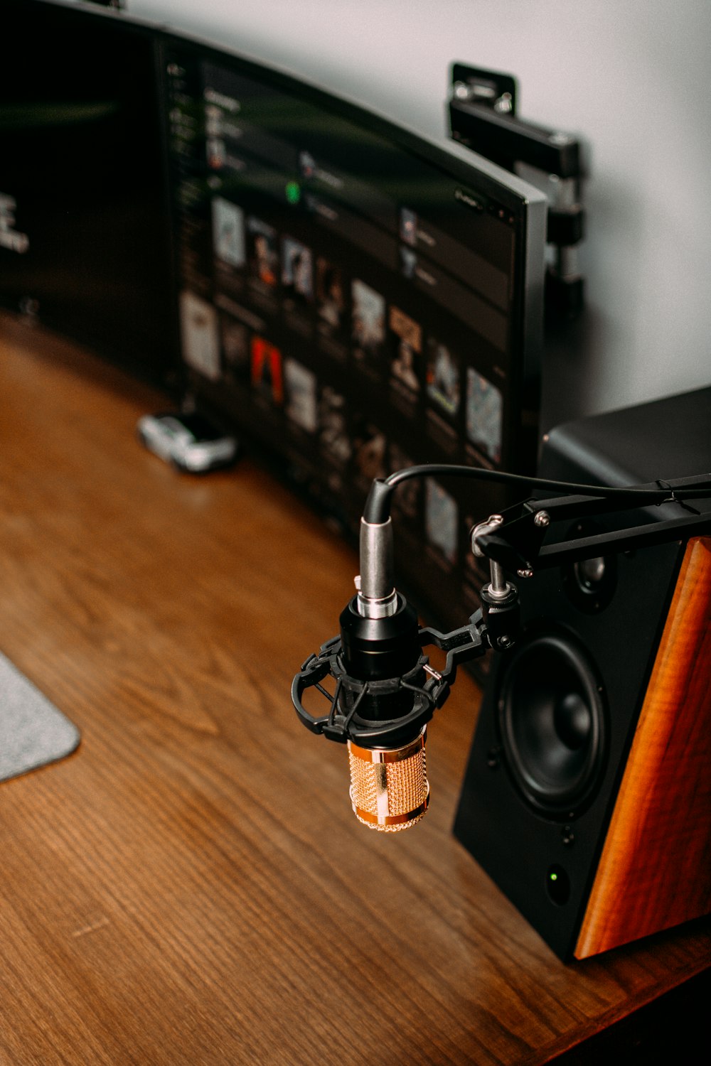 a black and silver speaker on a wooden surface