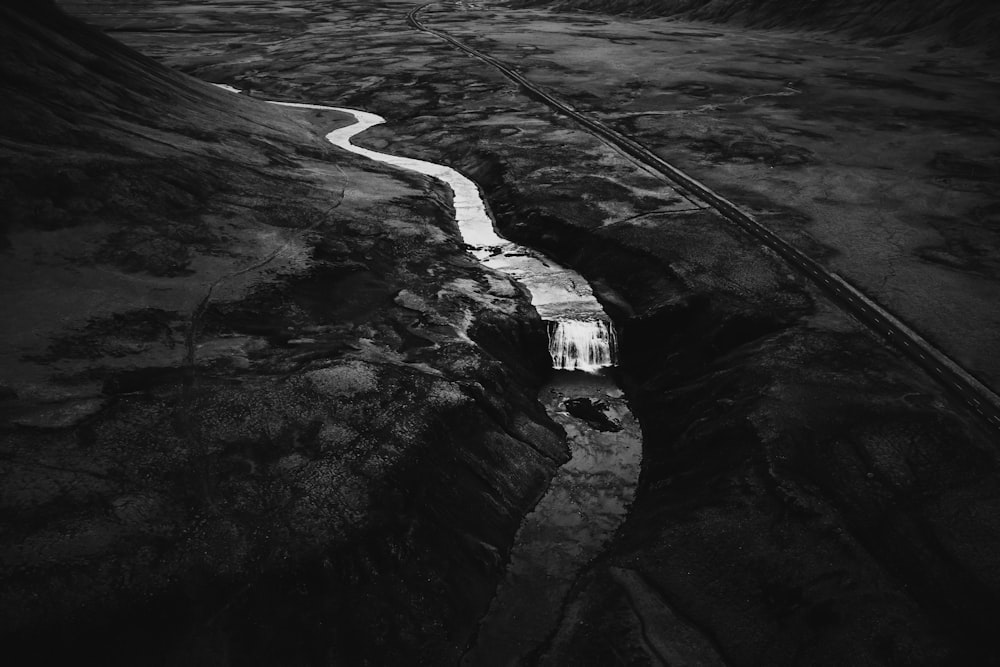 a black and white photo of a road with a white line on it