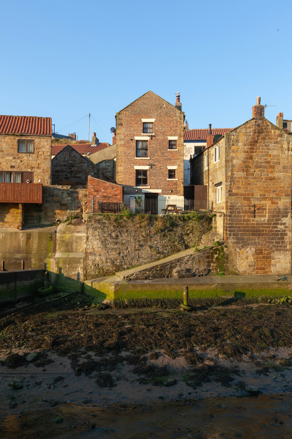 a stone wall with a stone wall and a stone wall with a stone wall and a grass field