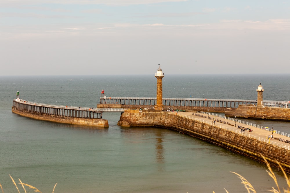 a pier with a light house on it and a light house on the end