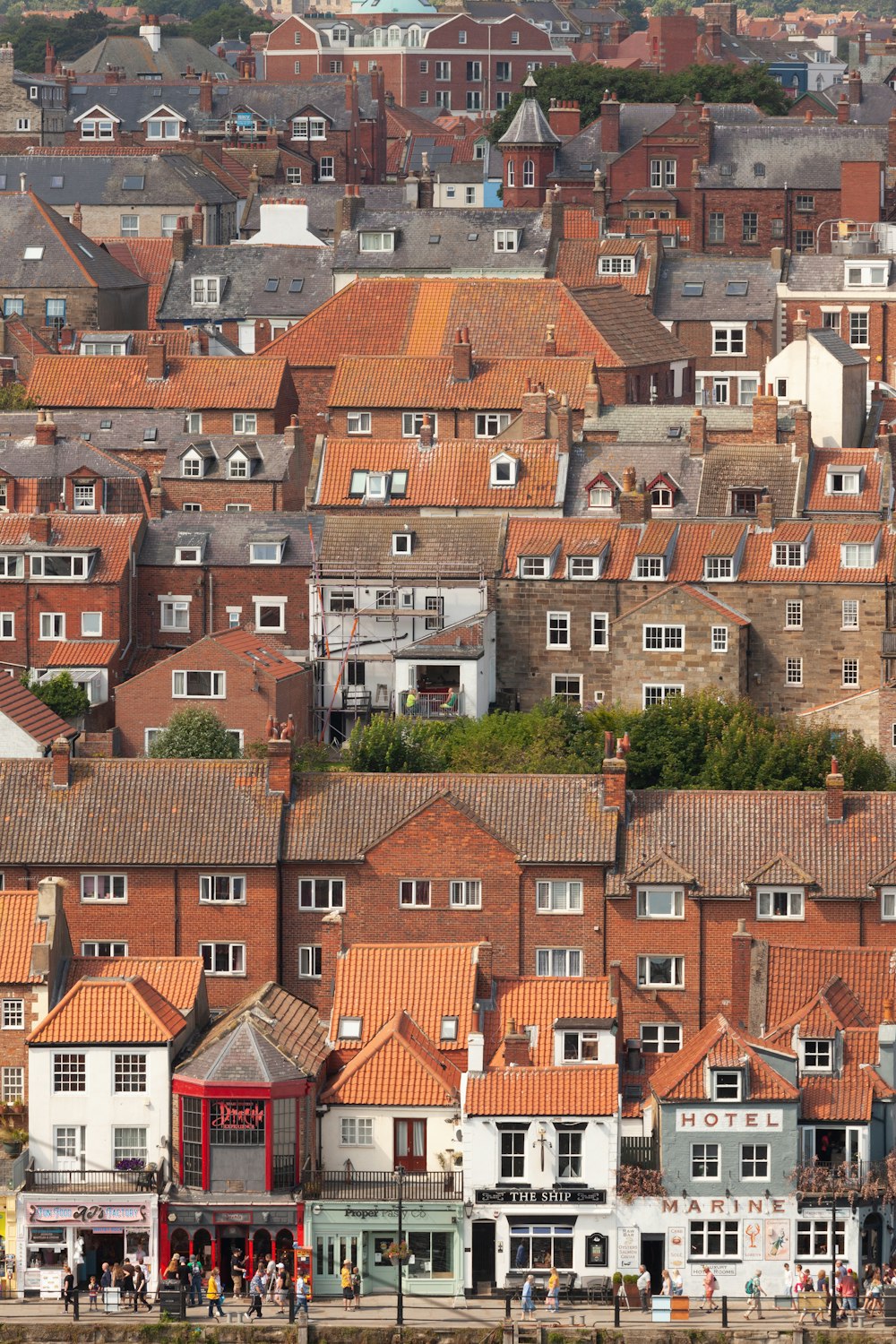 a group of buildings with people walking around