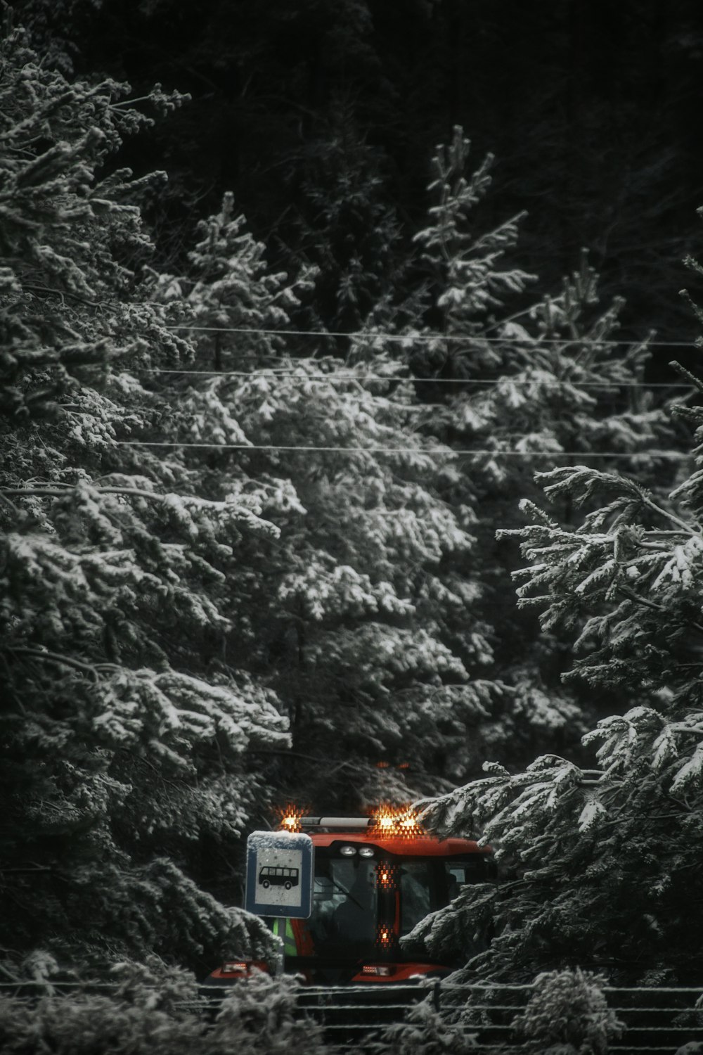 a snow covered bus in a snowy forest