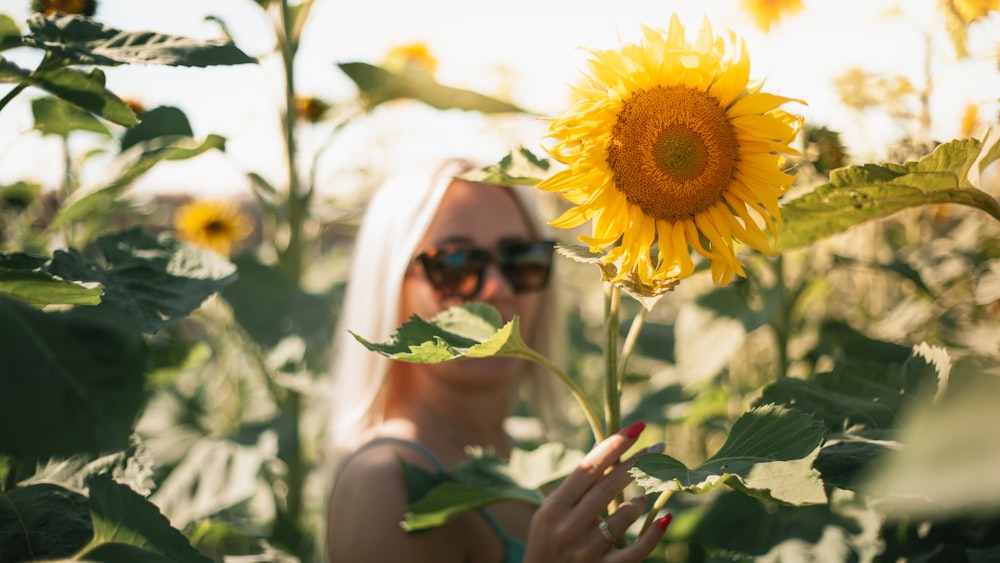 a person holding a sunflower