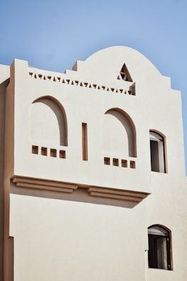 a white building with a round tower