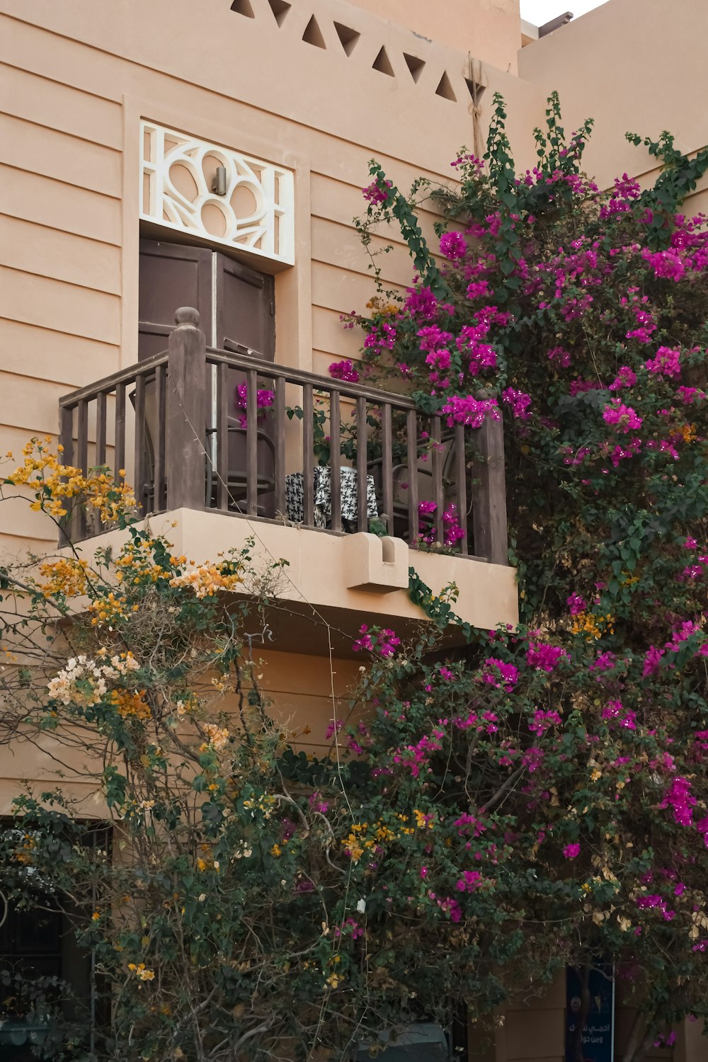 a balcony with flowers and trees