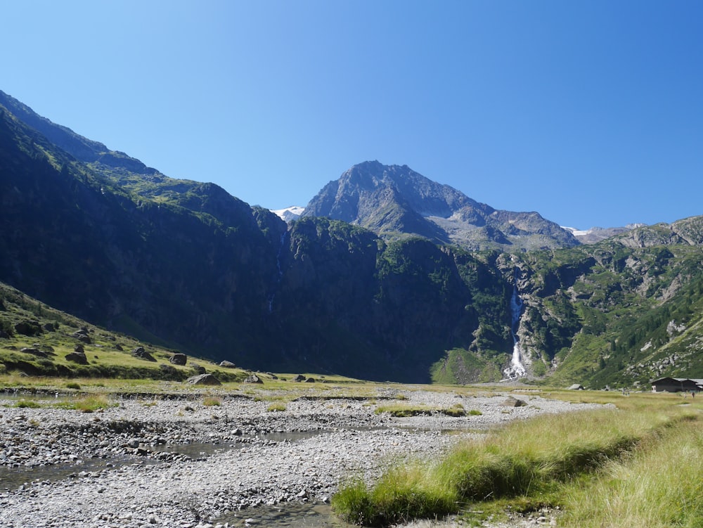 a river running through a valley between mountains