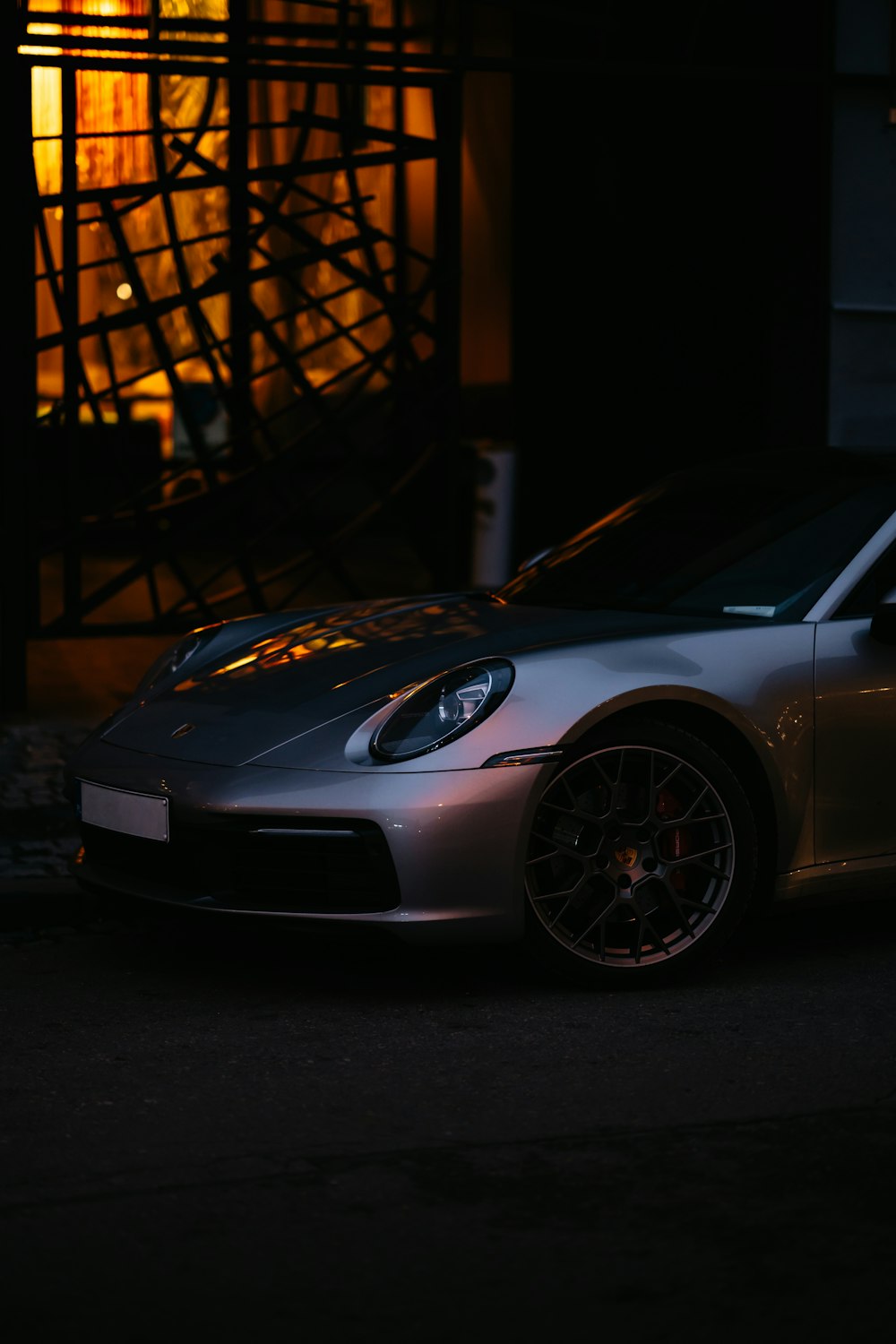 a white sports car parked in front of a cage