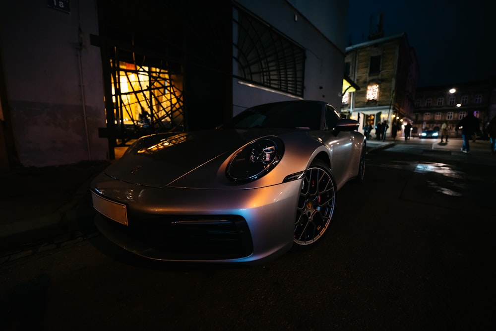 a car parked on the side of a street at night