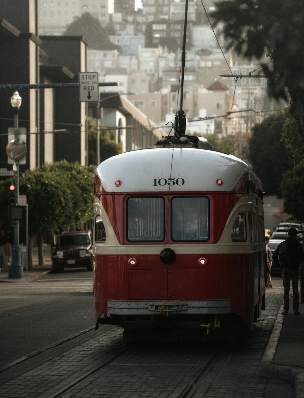 a red trolley car on a street