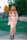A woman wearing fashionable flats while walking in a park.