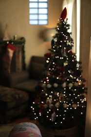A cozy fireplace decorated with Christmas stockings and twinkling lights.