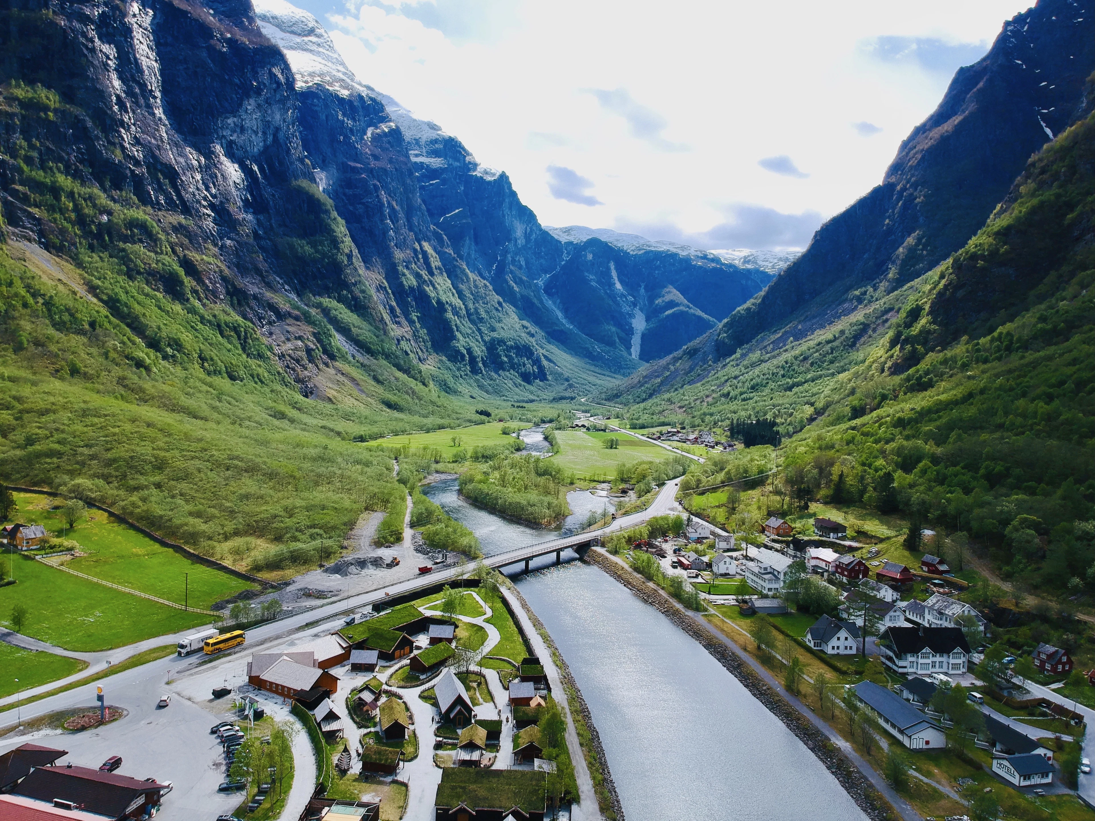 Gudvangen from the air: a river and village on the floor of a narrow valley between sheer mountains