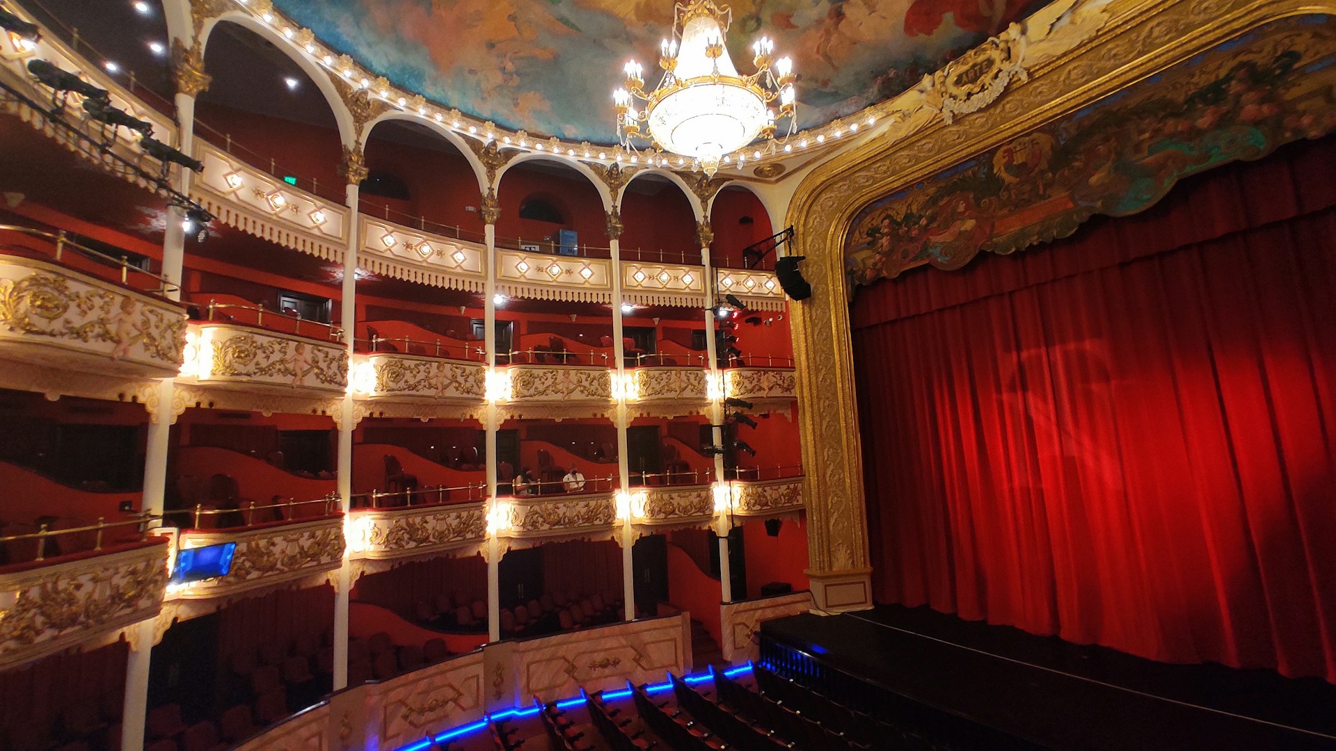 a room with a stage and a curtain