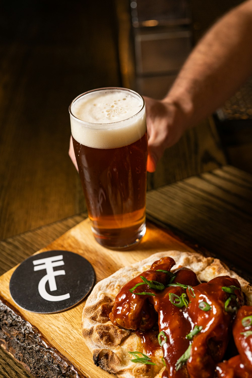 a beer and pizza on a table