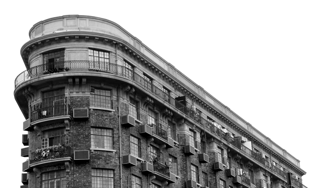 Shanghai Wukang Building showing the iconic curved Normandie Apartments facade at the Huaihai Road intersection