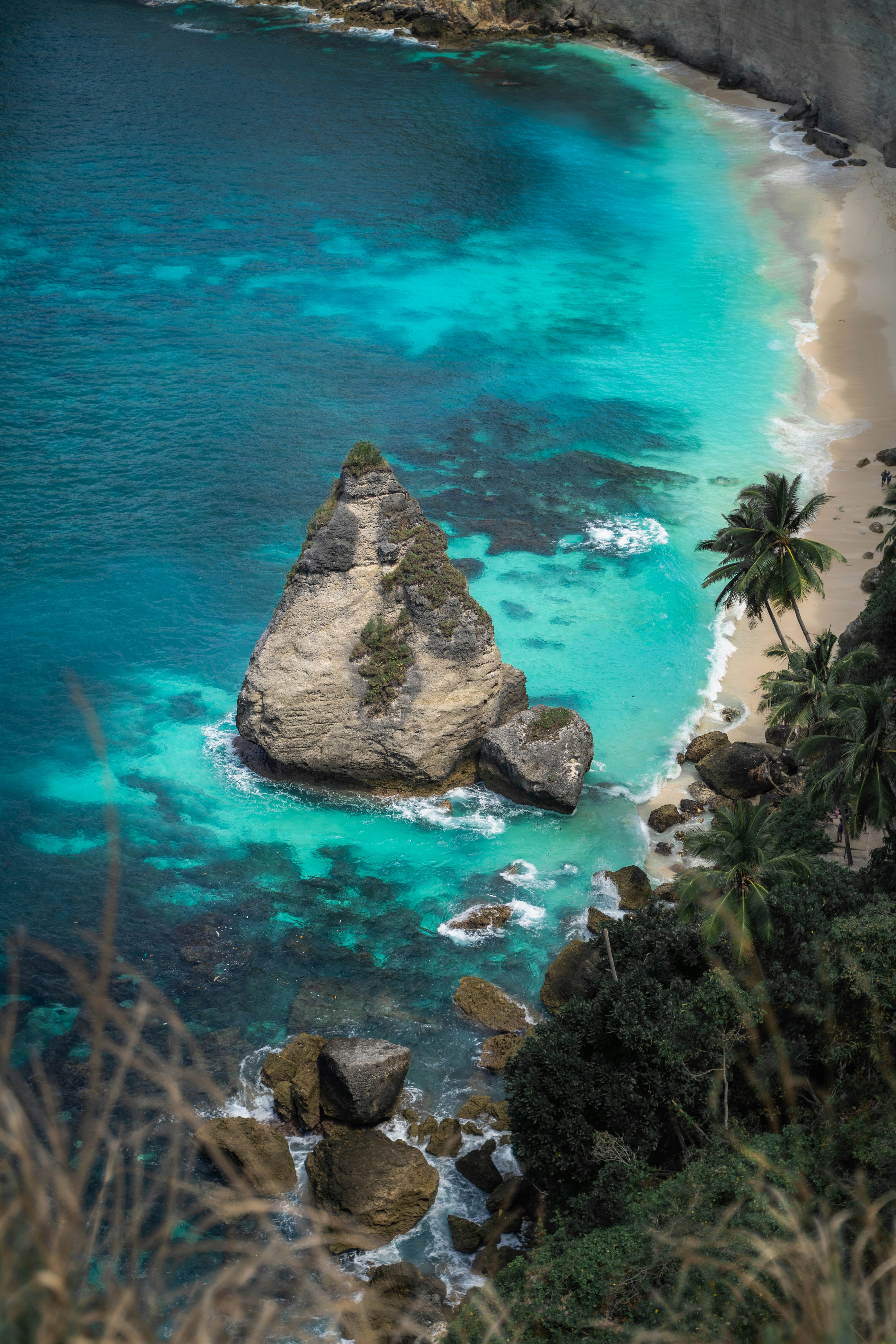 a rocky beach with a large rock in the water