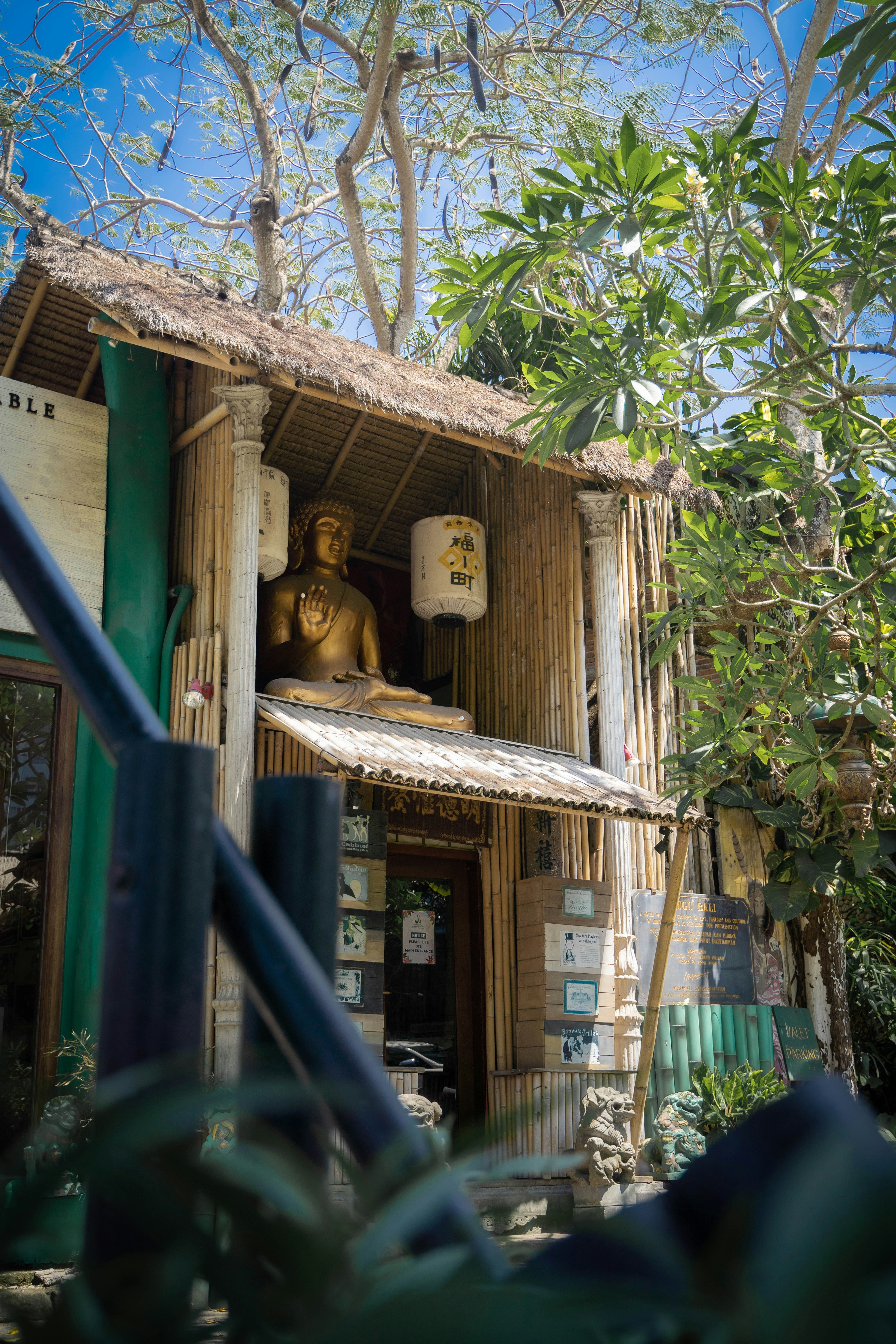 a wooden house with a statue in the window