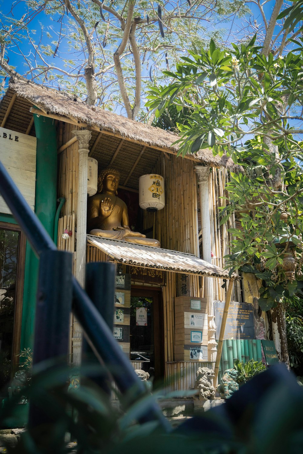 a wooden house with a statue in the window