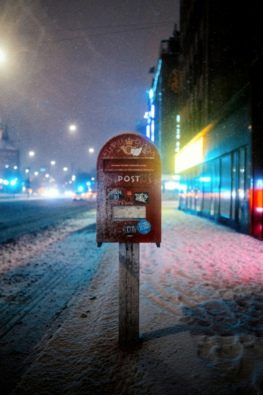 a parking meter on a snowy street