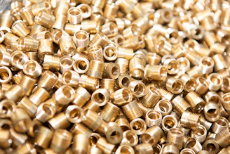 Array of freshly machined metal inserts ready for plastic molding tools.