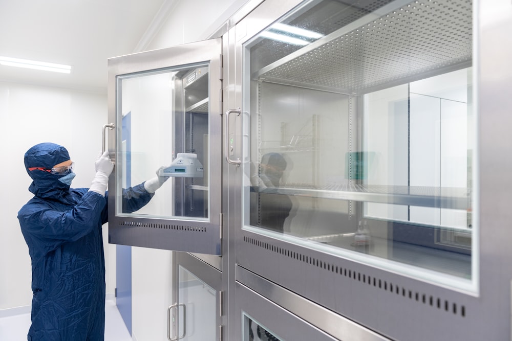 a person in a blue coat looking at a glass door