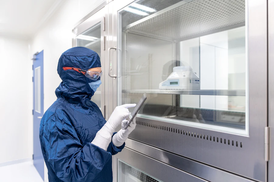 Gloved laboratory technician inspecting a product