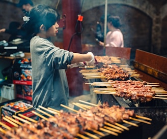 a person cooking food on a grill